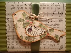 a piece of paper with music notes and a bird on it's back side