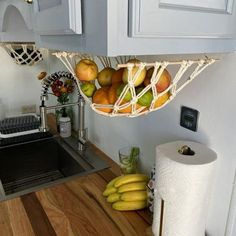 some fruit is in a basket on the kitchen counter