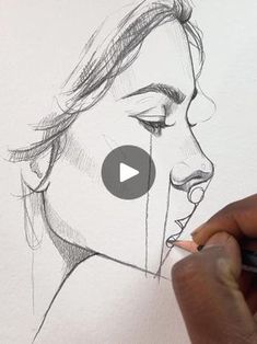 a person drawing a woman's face with a pencil