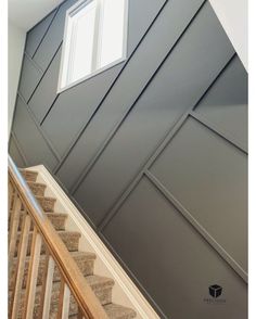 a stair case with an open window on the top and bottom panel, along with carpeted stairs