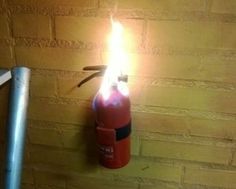 a fire extinguisher is lit up on the wall