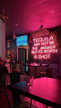 there is a neon sign that says tequila may not be the answer but it's worth a shot