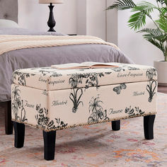 the foot stool is upholstered with flowers on it and sits in front of a bed