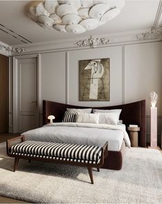 a bedroom with a large bed and white walls