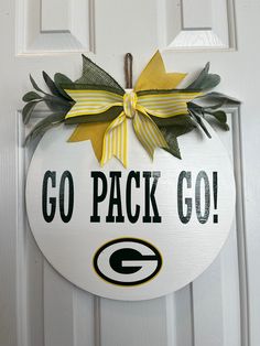 the green bay packers go pack go door hanger is hanging on a white door