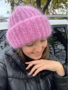 a young woman wearing a pink knitted hat