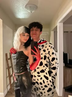 a man and woman dressed in costumes taking a selfie