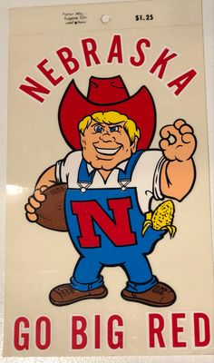 a sign that says,'go big red'with an image of a man in overalls and a cowboy hat