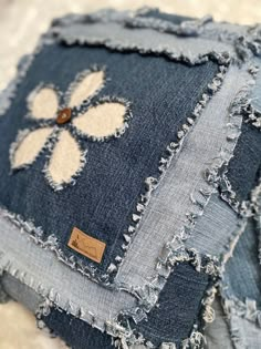 several pieces of denim with embroidered designs on them