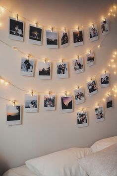 a bedroom with pictures hanging on the wall and string lights strung from the ceiling above it