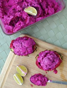 a wooden cutting board topped with purple food