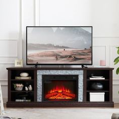 a flat screen tv sitting on top of a wooden entertainment center next to a fire place