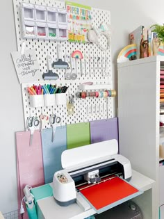 a sewing machine sitting on top of a table next to a wall mounted pegboard