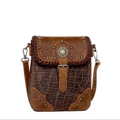 Made Of 100% Genuine Leather This Crossbody Has: Croc Embossed Patina Antique Gold Berry Concho Accented With Antique Silver Studs And Leather Whipstitch Flap With Magnetic Button Closure Top Zipper Closure Inside Of Clutch Include A Zippered Pocket And An Open Pocket A Zippered Pocket On The Back Detachable And Adjustable Shoulder/Crossbody Leather Strap 8.5" X 2" X 9.5" (Drop 24") Brown Crossbody Wallet, Brown Crossbody Saddle Bag With Cell Phone Pocket, Brown Textured Leather Crossbody Flap Bag, Leather Crossbody Wallet With Snap Closure, Leather Phone Bag With Snap Closure For Travel, Textured Leather Rectangular Saddle Bag, Rectangular Textured Leather Saddle Bag, Brown Textured Leather Crossbody Saddle Bag, Brown Textured Leather Saddle Crossbody Bag