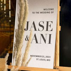 a welcome sign is displayed in front of a glass window with the words,'welcome to the wedding of jase and ann '