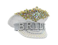 Sparkle, shine, and strut your fabulous self in this White And Gold Sequin Bride Captain Hat. Featuring beautiful white hat with gorgeous faux gems accented with gold trim and faux pearls in white, cream, and silver. Bride Banner accented with silver rhinestones. Hat stands about 7 inches tall, 11 inches long and is 10.5 inches wide. Fitting approximately 58 cm, each hat includes an elastic strap inside the opening for a more customized fit. Perfect for Weddings, Bachelorette Parties, Festivals Sequin Hat, Bride Hat, Festival Costumes, Sparkle Wedding, Hat Stands, Bachelorette Parties, White Hat, Gold Sequin, Silver Rhinestone