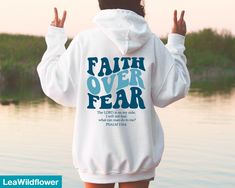 Looking for a christian bible verse hoodie ? Our faith over fear hoodie is the perfect gift for all! It's made of a soft comfortable blend of high-quality materials and is sure to last for years to come. It's perfect for wearing on a cold day, out for a hike, or just lounging around the house. ★Shipping This is a made to order item Our turn around time is 1 to 3 business days. If you need any item by a certain date, please message us and we'll see what we can do! ★Size This sweatshirt is unisex Cheap Solid Color Hoodie With Letter Print, Back Aesthetic, It Hoodie, Happy Hoodie, Vsco Hoodie, Positive Hoodie, Push It