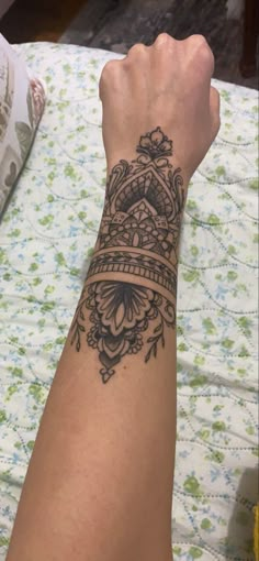 a woman's arm with a crown tattoo on it