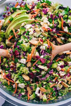 a salad with broccoli, carrots, red cabbage and avocado