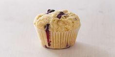 a blueberry muffin sitting on top of a white table