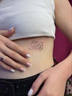 a woman's stomach with a tattoo on it