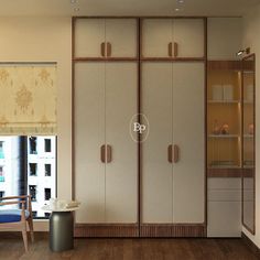 an empty room with wooden flooring and white cupboards on the wall, next to a blue chair