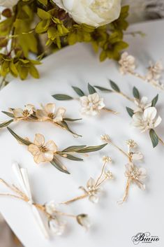 "Introducing our exquisite \"Abelia\" flower hair accessory, a graceful and captivating addition to any bridal ensemble or special occasion look. This elegant set features two delicate white flowers pieces, meticulously crafted to exude timeless beauty and charm. Each flower is adorned with lustrous pearls that add a touch of sophistication and enchantment, catching the light with every movement. The set includes a matching pair of dainty flower earrings, designed to perfectly complement the hai Wedding Earrings Bride Hair Down, Hair Accesories Wedding, Floral Hair Clip Wedding, Bride Hair Down, Art Nouveau Weddings, Flower Hair Pieces, Bead Hair Accessories, Floral Hair Clip, Floral Comb