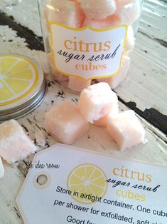 a jar filled with sugar cubes next to a lemon slice and some other items