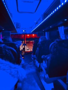 the inside of a bus with people sitting in it