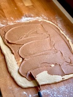 a homemade peanut butter sandwich on a wooden cutting board