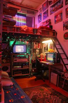 a loft bed with lots of electronics and pictures on the wall