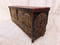 an old wooden box with ornate designs on it