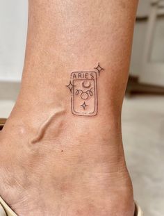 a small tattoo on the ankle of a woman's foot that reads aris go