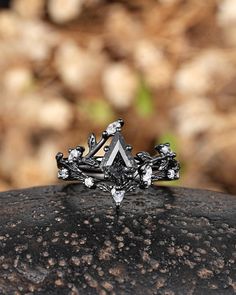 a diamond ring sitting on top of a rock