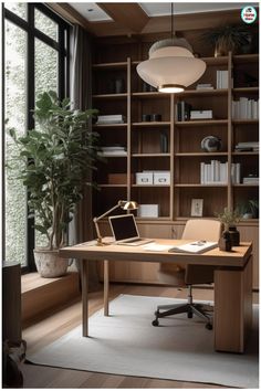 a desk with a laptop on it in front of a book shelf filled with books