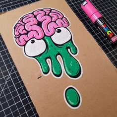 a piece of paper with a drawing of a brain on it next to crayon markers