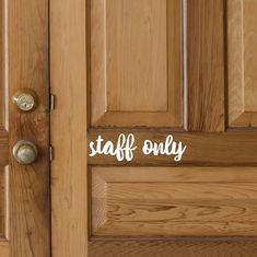 a wooden door with the words staff only on it