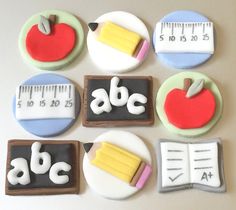 decorated cookies are arranged in the shape of letters and numbers with school supplies on them