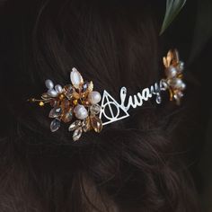 a close up of a hair comb with flowers and pearls on it's head