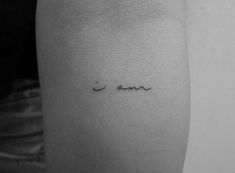 a woman's arm with the word love written in cursive writing on it