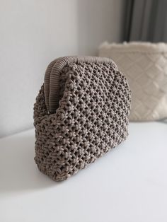 a crocheted purse sitting on top of a white table