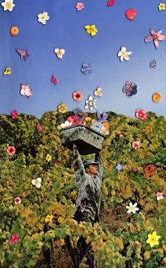 a man carrying a bucket on his head in a field full of flowers and butterflies