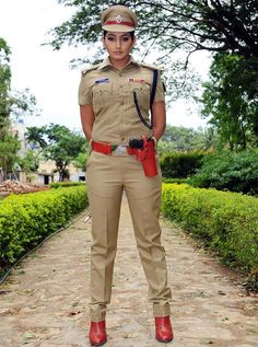 a woman in uniform standing on a path