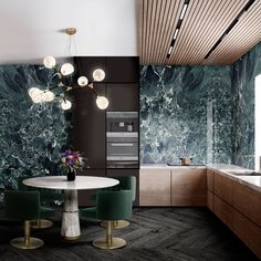 a kitchen with marble walls and flooring, green chairs around a white round table