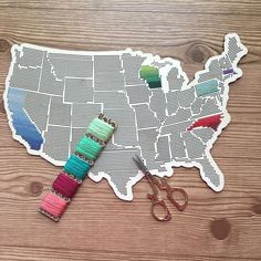 the united states is made out of paper with thread spools and scissors on it