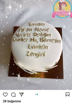 a white cake with gold writing on it