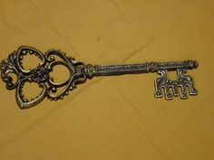 an antique key with two keys attached to it