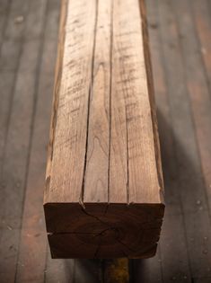 a wooden bench sitting on top of a hard wood floor