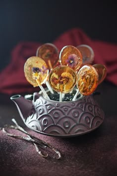 some candies are sitting in a silver bowl