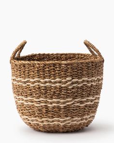 a woven basket with two handles on the top and one handle at the bottom, sitting in front of a white background